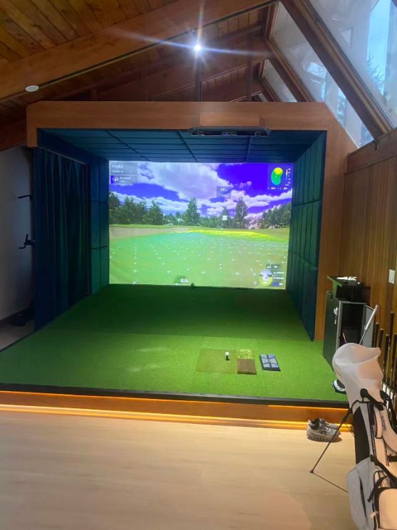 The same sunroom with a padded RG simulator enclosure, impact screen and raised turf platform